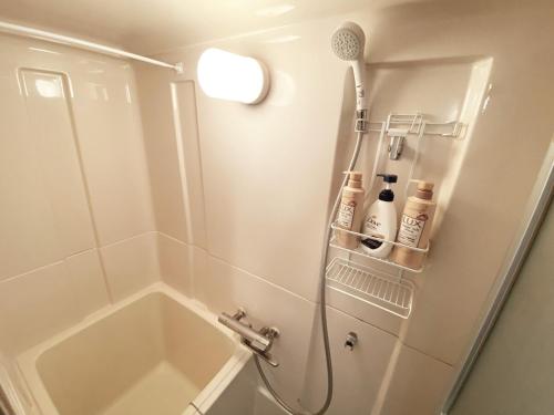 a bathroom with a shower with a tub and a sink at 1min walk to sta, Many food, Near Shibuya and HND in Tokyo