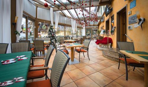 a restaurant with tables and chairs with christmas decorations at Hotel Restaurant Freihof in Oberharmersbach