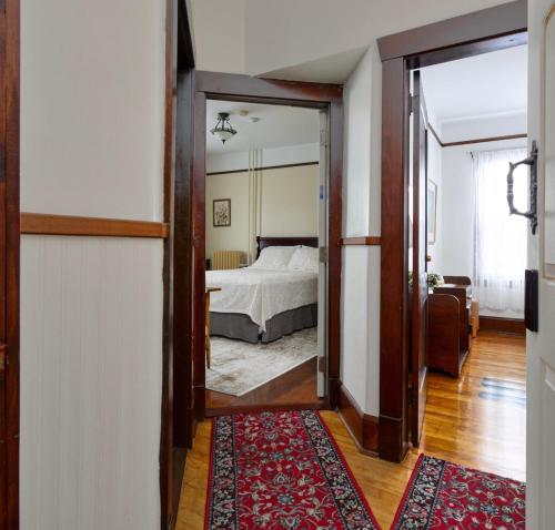 a bedroom with a bed and a large mirror at Royal Hotel Sydney in Sydney