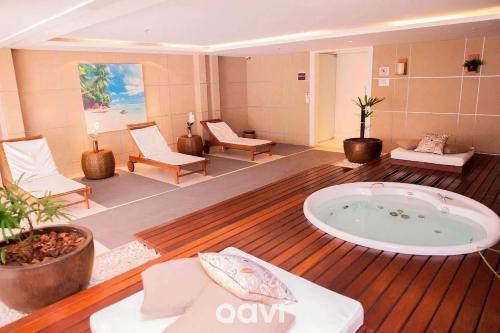 a large room with a jacuzzi tub in the middle at Qavi - Flat Sofisticado Beira Mar Cotovelo #IMB325 in Parnamirim