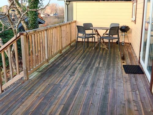 a deck with a table and chairs on it at 4 star holiday home in Heberg in Heberg