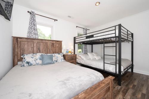 a bedroom with two bunk beds and a giraffe statue at Arcade, Ping Pong, Hot Tub, Gas Grill, & King Bed in Kernersville