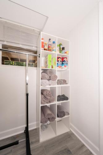 a closet with white shelves and a window at Arcade, Ping Pong, Hot Tub, Gas Grill, & King Bed in Kernersville