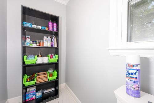 a shelf in the corner of a bathroom with products at Arcade, Ping Pong, Hot Tub, Gas Grill, & King Bed in Kernersville