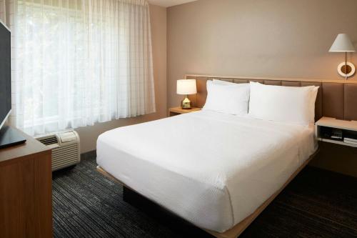 a hotel room with a large bed and a window at TownePlace Suites Winchester in Winchester