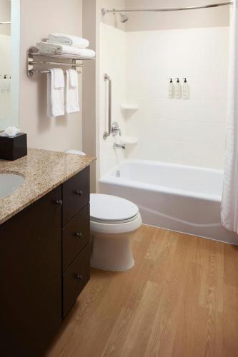 a bathroom with a toilet and a tub and a sink at TownePlace Suites Winchester in Winchester