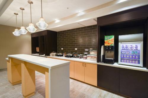 a large kitchen with a counter and a drink machine at TownePlace Suites by Marriott Slidell in Slidell