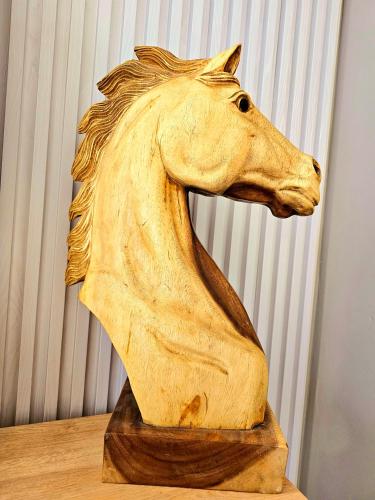 a wooden horse statue sitting on top of a table at Premium Beachfront Residences in Durrës