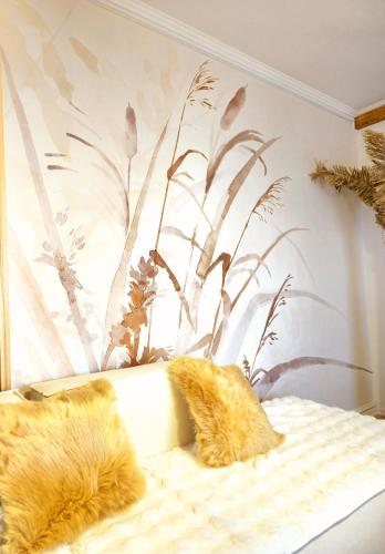 a bedroom with a bed with two furry pillows on it at Premium Beachfront Residences in Durrës