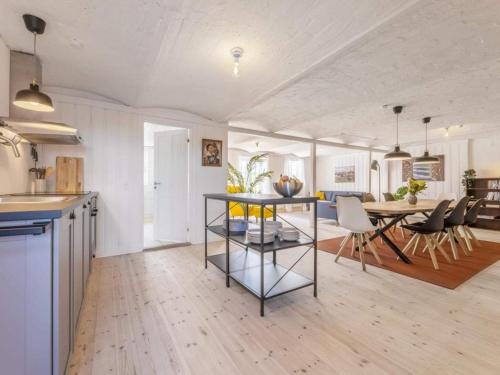 a kitchen and living room with a table and chairs at Cozy Coastal Retreat - By Traum Ferienwohnungen in Hjørring