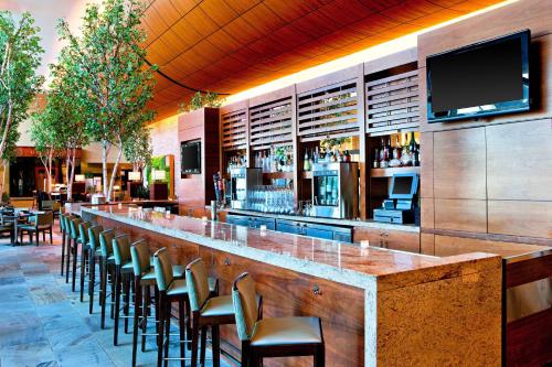 a bar with chairs and a flat screen tv at The Westin Boston Seaport District in Boston