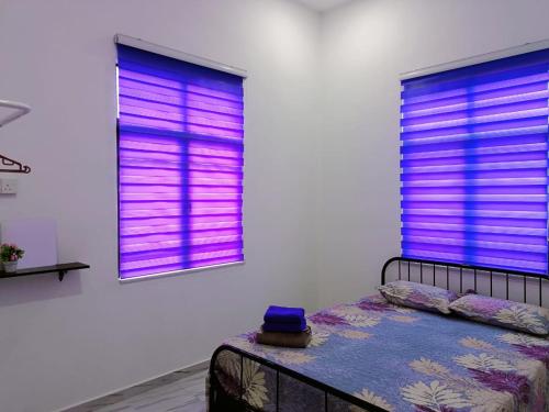 a bedroom with purple blinds on two windows at Hannan Homestay Kuala Terengganu in Kuala Terengganu
