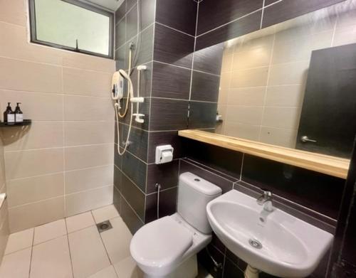 a bathroom with a toilet and a sink at Furusato Midori Green- Tmn Mount Austin at Johor Bahru in Johor Bahru