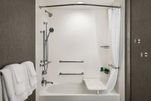 a white bathroom with a tub and a sink at SpringHill Suites by Marriott Milwaukee West/Wauwatosa in Wauwatosa