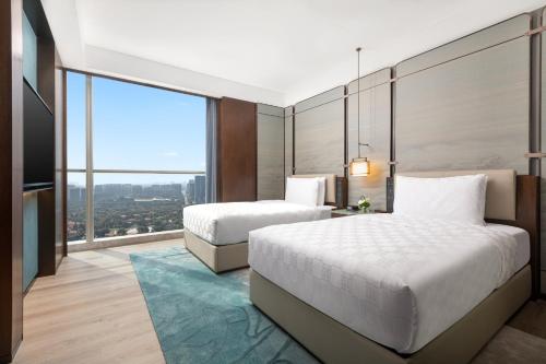 Postel nebo postele na pokoji v ubytování HUALUXE Hotels and Resorts Haining