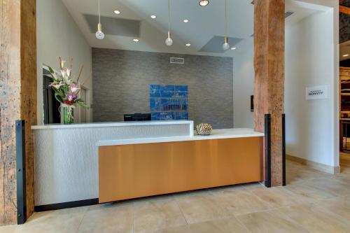 a lobby with a reception desk and flowers at SpringHill Suites by Marriott Montgomery Downtown in Montgomery
