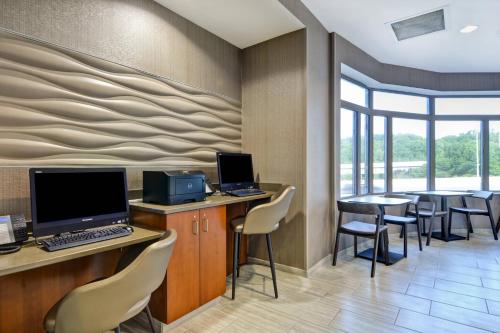 an office with a desk with a computer and chairs at SpringHill Suites by Marriott Cincinnati Midtown in Cincinnati
