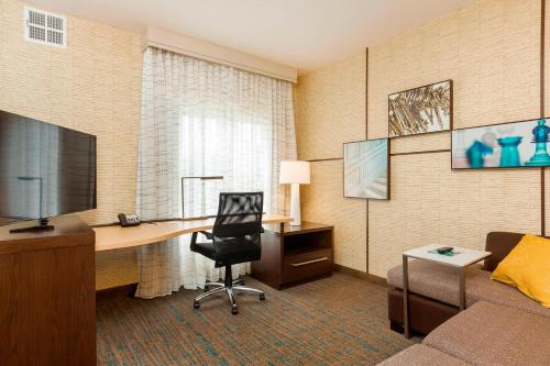 a hotel room with a desk and a couch at Residence Inn by Marriott Portland Hillsboro/Brookwood in Hillsboro