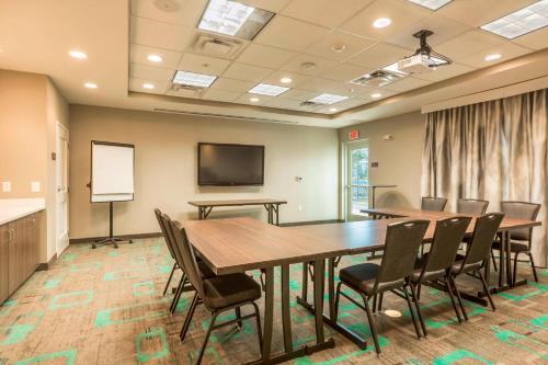 a conference room with tables and chairs and a screen at Residence Inn by Marriott Portland Hillsboro/Brookwood in Hillsboro
