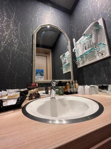 a bathroom with a sink and a mirror at Fun3 -Adult Only- in Yokohama