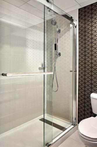 a glass shower in a bathroom with a toilet at Los Angeles Airport Marriott in Los Angeles