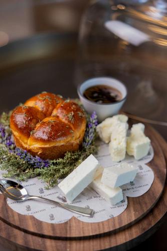 a plate of food with bread and cheese on a table at The Ritz-Carlton, Baku in Baku