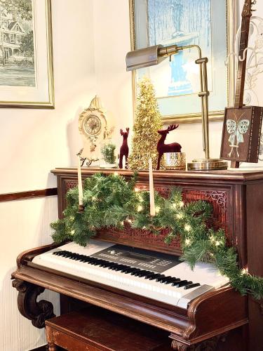 an old piano with christmas decorations on it at Royal Hotel Sydney in Sydney