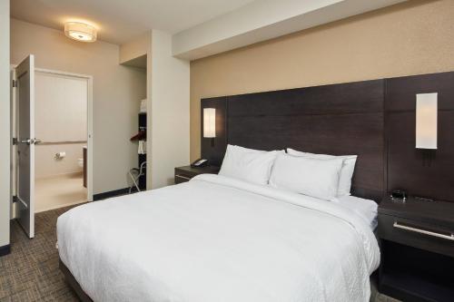a large white bed in a hotel room at Residence Inn Sacramento Davis in Davis