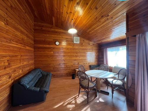 a living room with a couch and a table at 富士山サクラリゾート in Kai