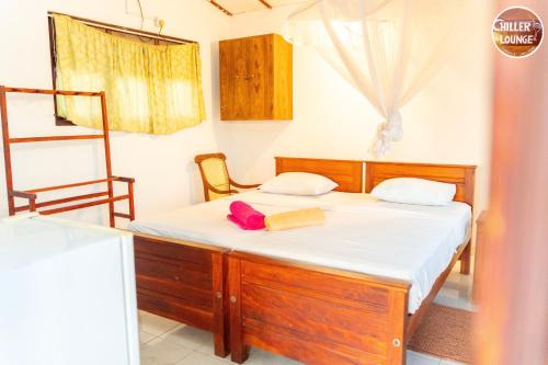 a bedroom with a bed with a book on it at Chiller Jone's place in Tangalle