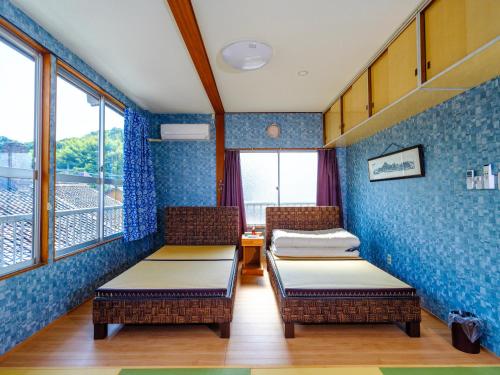 Una cama o camas en una habitación de ゲストハウス みるか