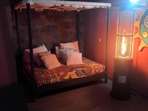 a bedroom with a canopy bed with a lamp at CASA SORAYA El Medano in El Médano