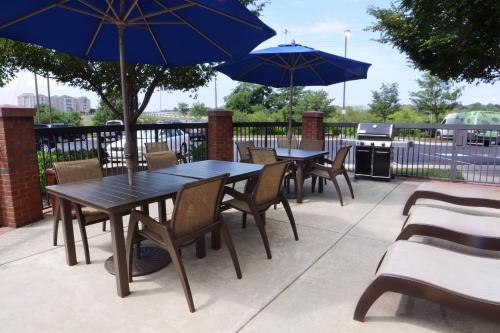 a group of tables and chairs with umbrellas at SpringHill Suites Dulles Airport in Sterling
