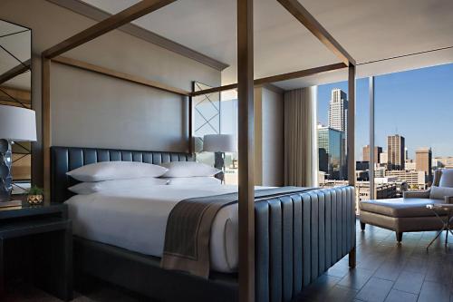 a bedroom with a bed and a view of a city at Omaha Marriott Downtown at the Capitol District in Omaha