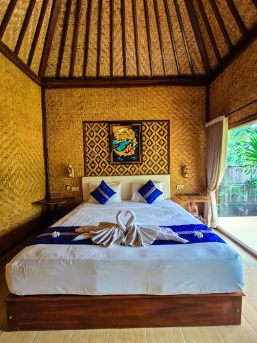 a bedroom with a large bed in a resort at Wadon Menjangan homestay in Banyuwedang