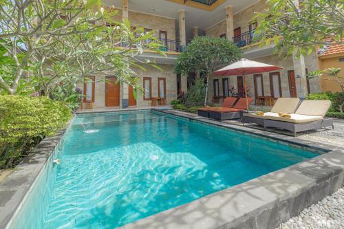 a swimming pool in the backyard of a house at The Bingin Sari Jimbaran in Jimbaran
