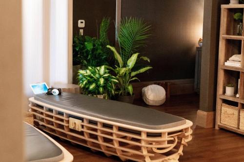 a large wicker bench in a room with plants at JW Marriott Nashville in Nashville