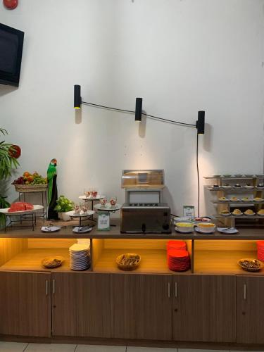 a kitchen with a counter with plates of food at Graha Widya Bhakti at STIESIA Surabaya in Surabaya