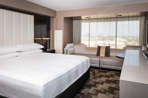 a hotel room with a bed and a couch at Beverly Hills Marriott in Los Angeles
