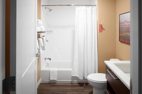 a bathroom with a white shower curtain and a toilet at TownePlace Suites by Marriott Danville in Danville