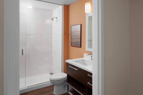 a bathroom with a shower and a toilet and a sink at TownePlace Suites by Marriott Danville in Danville