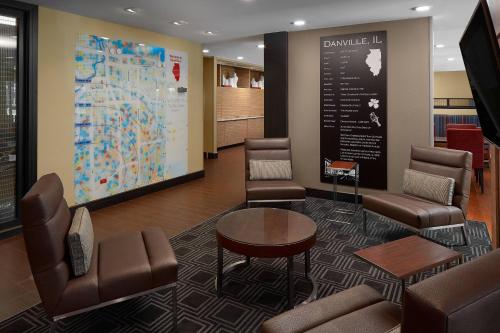 a waiting room with chairs and a map on the wall at TownePlace Suites by Marriott Danville in Danville