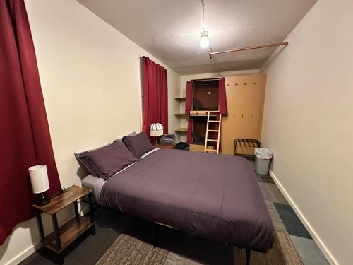 a bedroom with a large bed with purple sheets at West River House in Truckee