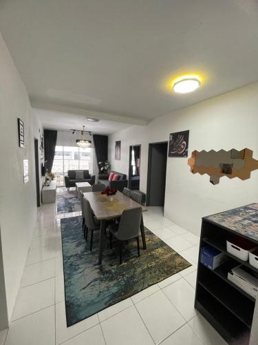 a dining room and living room with a table and chairs at Amy Homestay in Brinchang