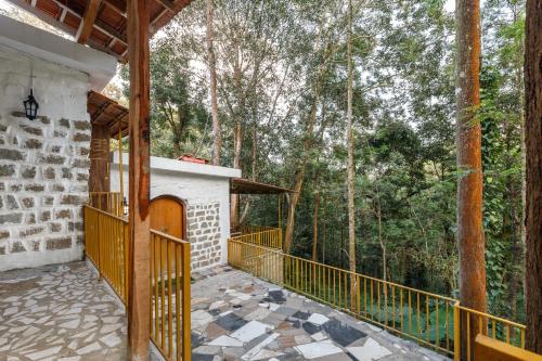a balcony of a house with trees in the background at Jungle stay by Bilwa Estate in SanivÄrsante