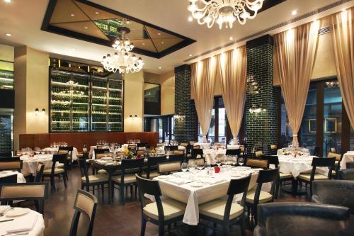 a restaurant with tables and chairs and a chandelier at JW Marriott Hotel Mexico City Santa Fe in Mexico City