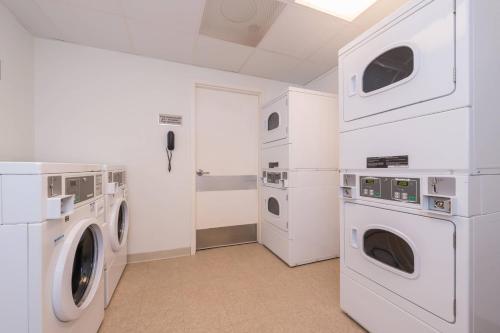 a laundry room with white appliances and a washer and dryer at SpringHill Suites by Marriott Huntsville Downtown in Huntsville