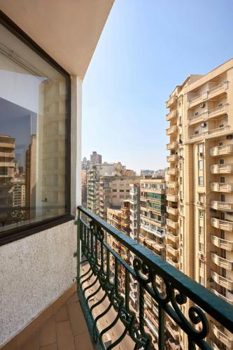 a balcony with a bench looking out at a city at Sheraton Montazah Hotel in Alexandria