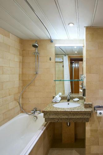 a bathroom with a sink and a bath tub at Sheraton Montazah Hotel in Alexandria