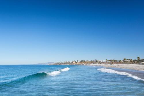 a view of a beach with a wave in the ocean at Sheraton Carlsbad Resort & Spa in Carlsbad